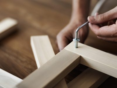 Woman screwing in chair’s nail for ready-to-assemble furniture