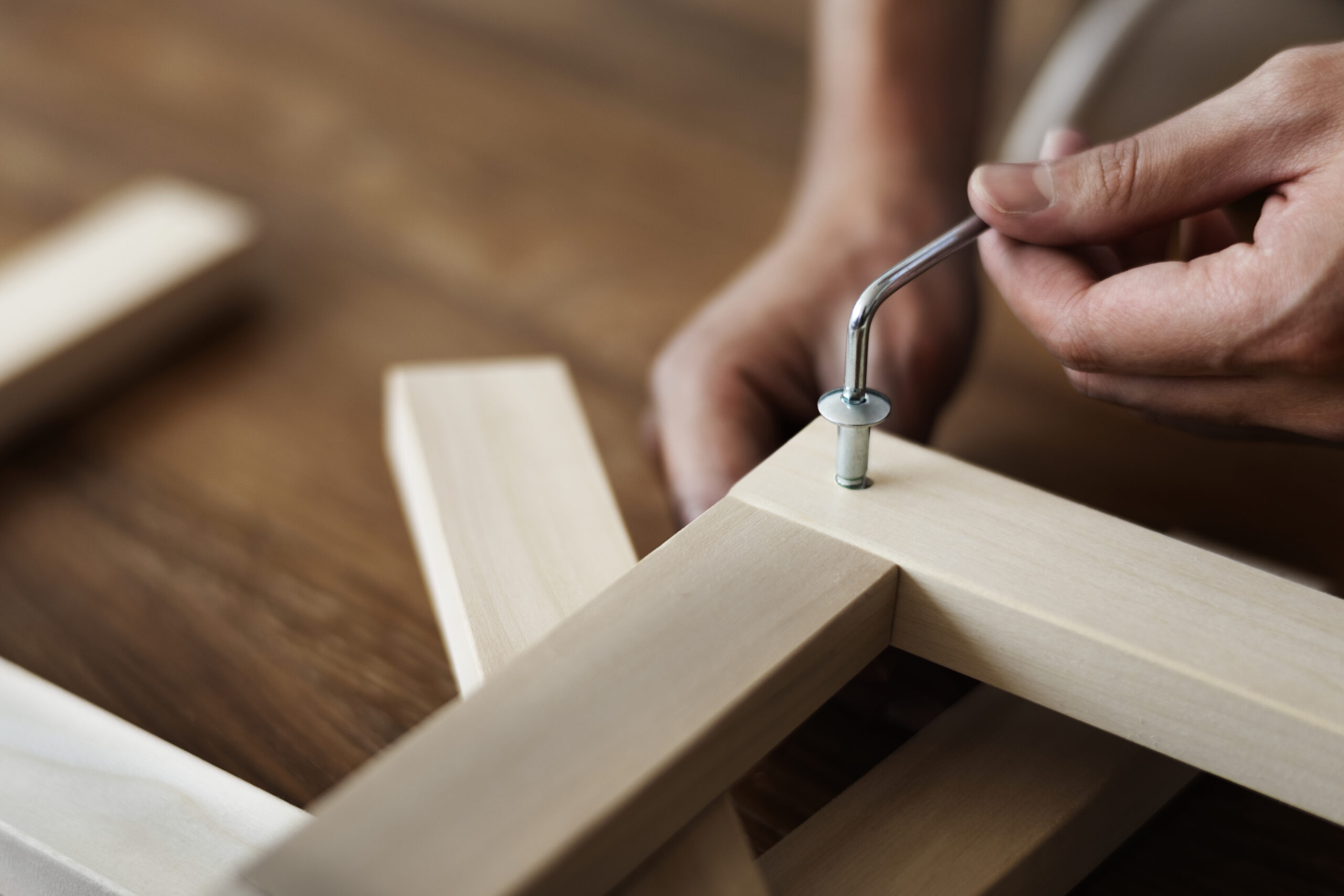 Woman screwing in chair’s nail for ready-to-assemble furniture